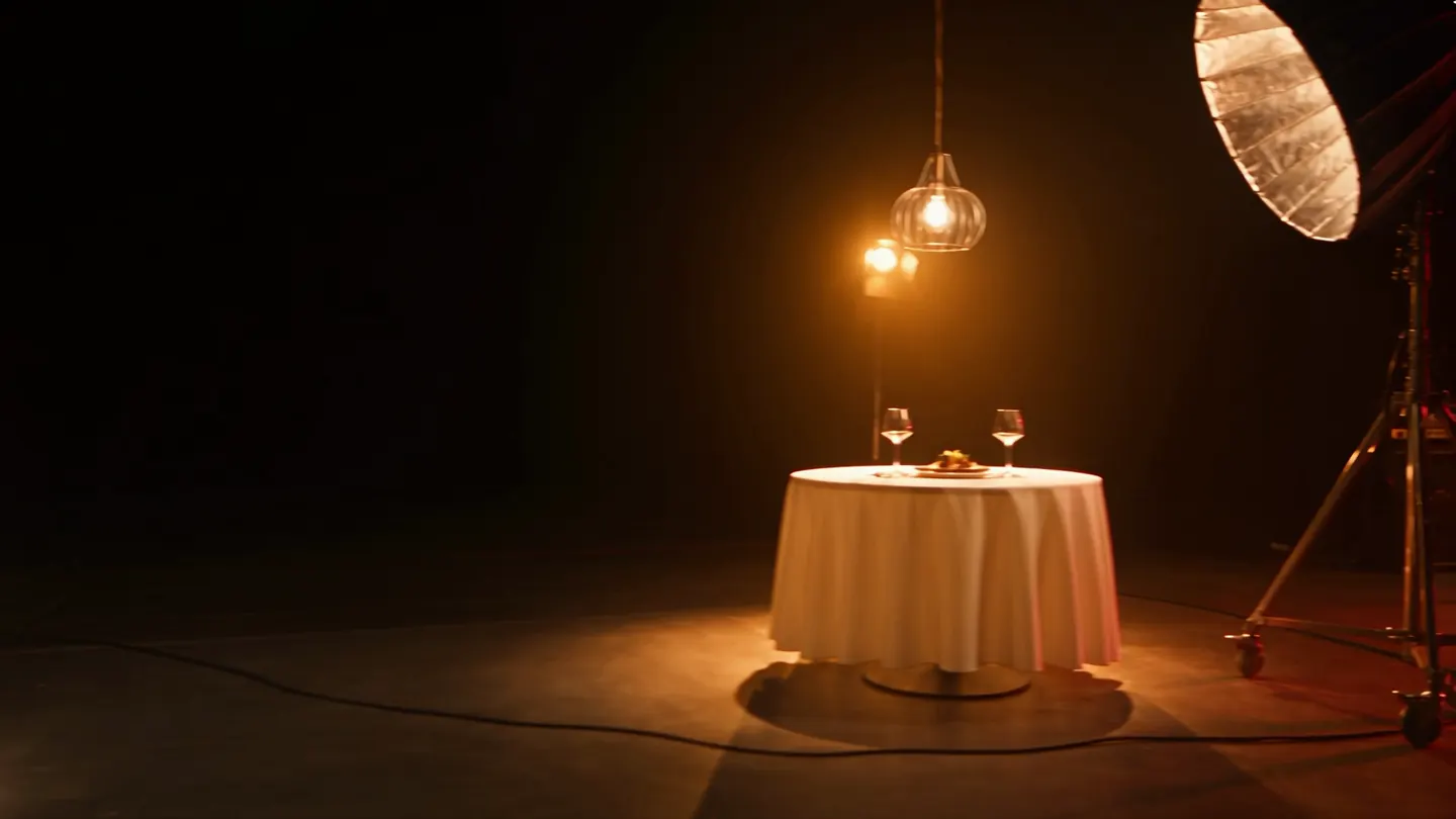 The restaurant set: a table laid under a warm lamp.