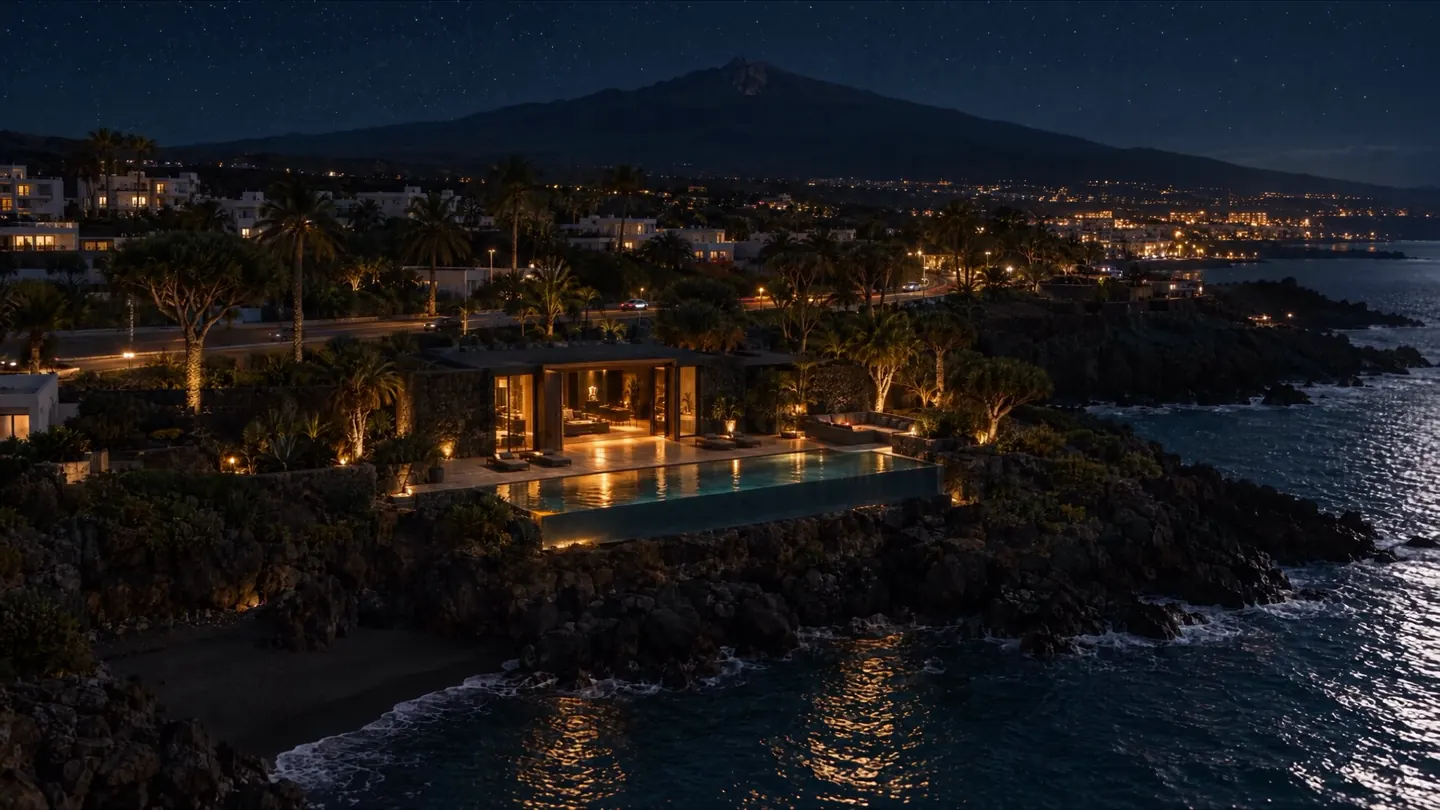 From above, at night: the studio on the cliff with its pool, the Tenerife coast and Mount Teide under the stars.